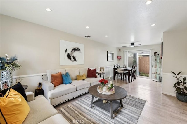 living area featuring light wood-style floors, baseboards, visible vents, and recessed lighting