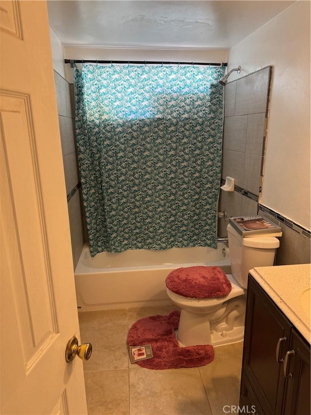 full bath with toilet, tile patterned floors, shower / bath combo with shower curtain, and vanity