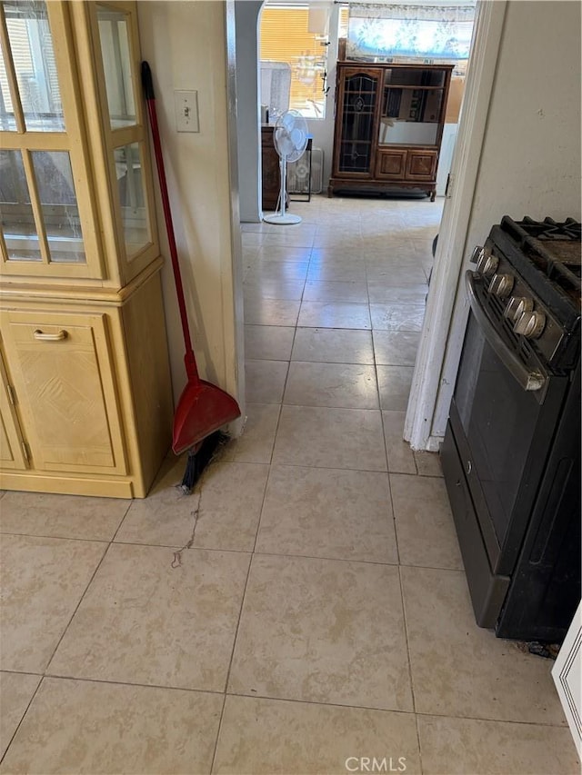 hall with light tile patterned floors