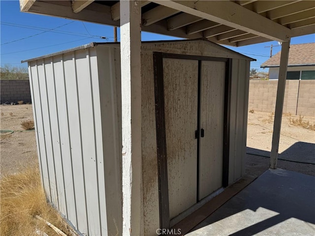 view of shed featuring fence