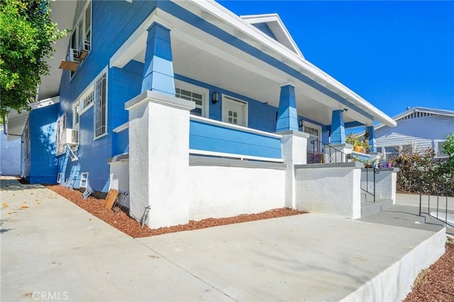 view of front of home with a balcony and stucco siding