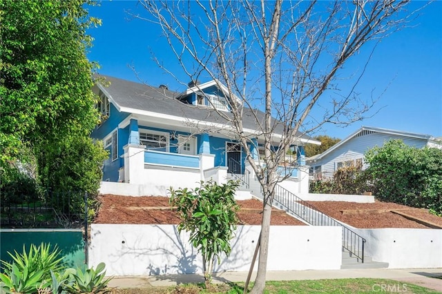 view of front of house featuring stairway and stucco siding