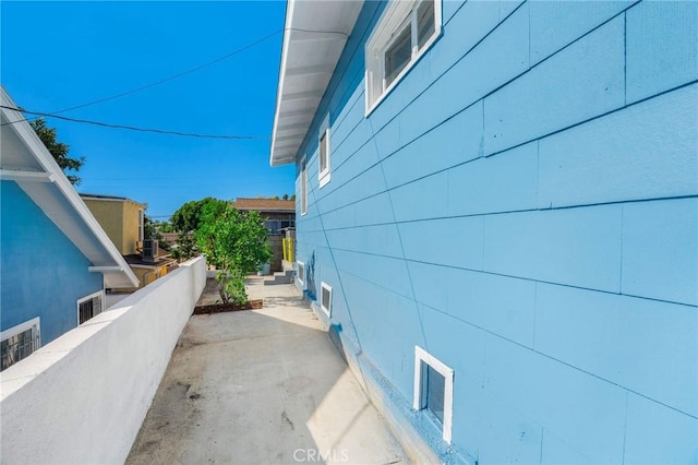 view of property exterior featuring a patio and fence