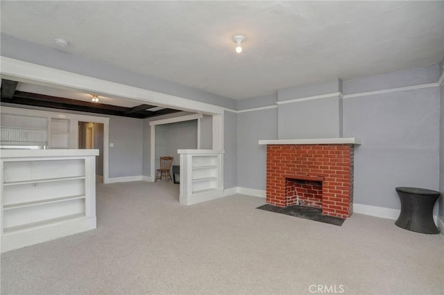 unfurnished living room with a brick fireplace, baseboards, and light colored carpet