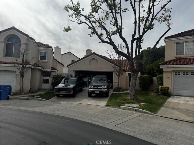 multi unit property with driveway, a garage, and stucco siding