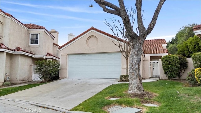 mediterranean / spanish house with driveway, a tiled roof, an attached garage, and stucco siding