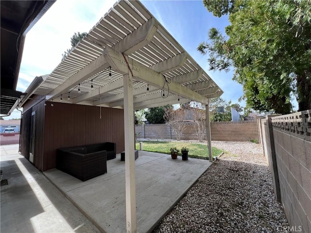 view of patio / terrace featuring a fenced backyard and a pergola