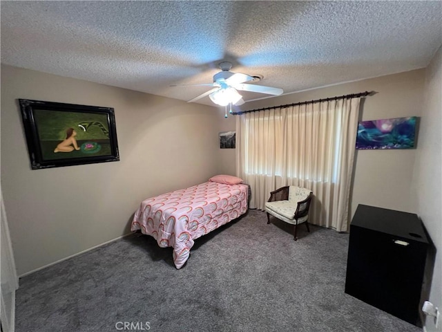 bedroom featuring a ceiling fan, carpet flooring, and a textured ceiling