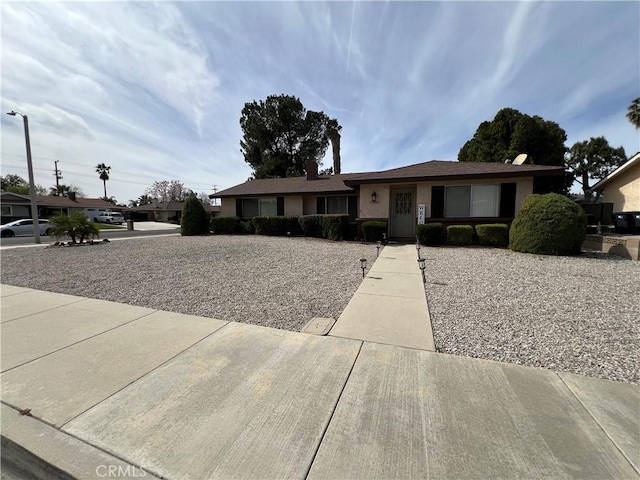 ranch-style house with stucco siding