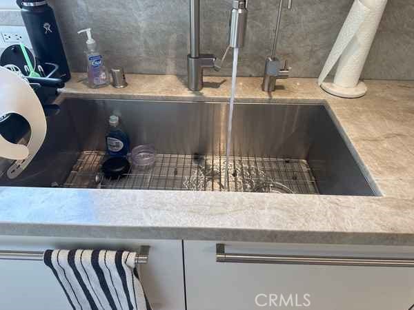 details featuring light countertops and a sink