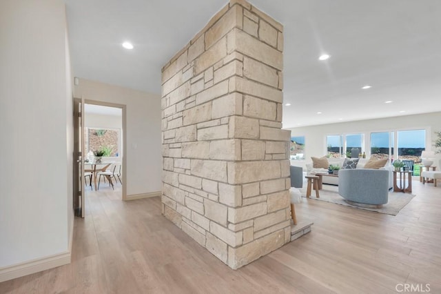 corridor with recessed lighting, plenty of natural light, and light wood finished floors