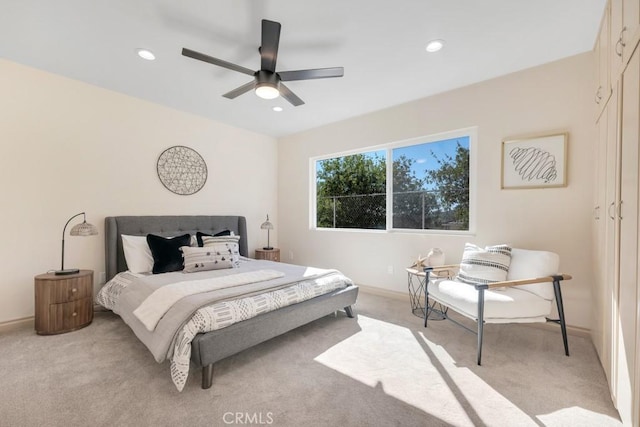 bedroom featuring light carpet, baseboards, a ceiling fan, and recessed lighting