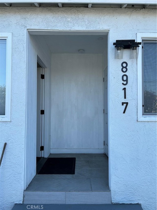 doorway to property with stucco siding