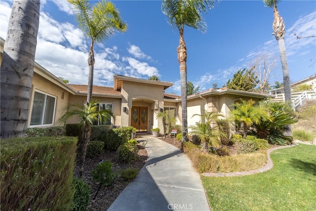 view of front of home featuring french doors and stucco siding