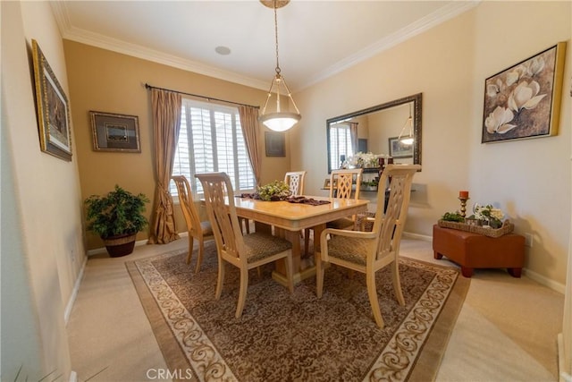 dining room featuring light carpet, ornamental molding, and baseboards