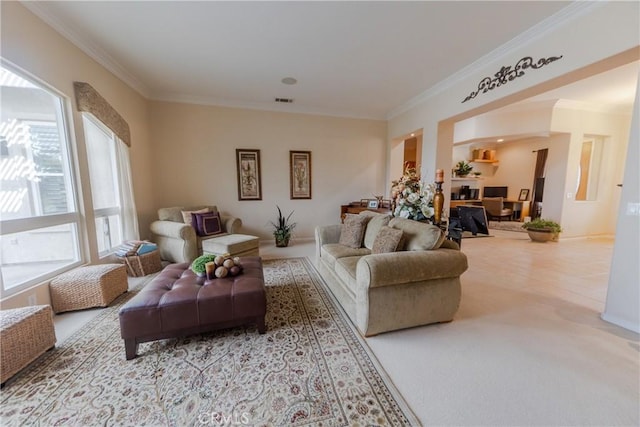 carpeted living room with ornamental molding and visible vents