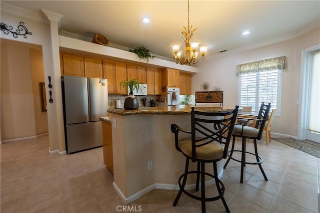 kitchen with white appliances, light tile patterned floors, ornamental molding, a chandelier, and backsplash