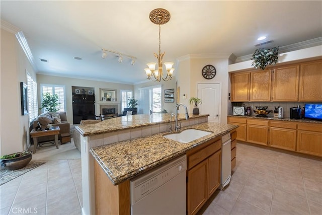 kitchen featuring a fireplace, light tile patterned floors, visible vents, a sink, and dishwasher