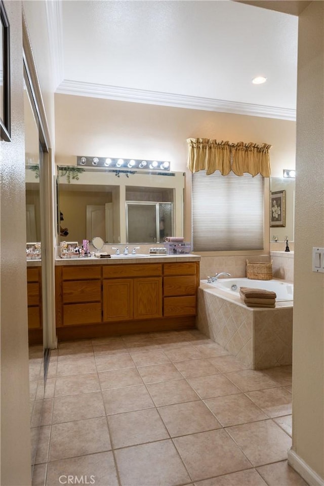 bathroom featuring tile patterned flooring, a garden tub, vanity, ornamental molding, and a stall shower