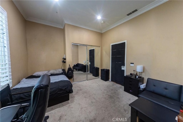 bedroom featuring a closet, visible vents, carpet flooring, and ornamental molding