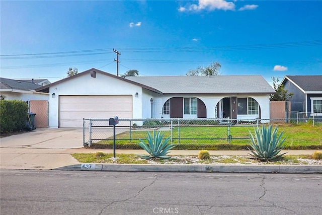 single story home with a fenced front yard, a front yard, driveway, and stucco siding