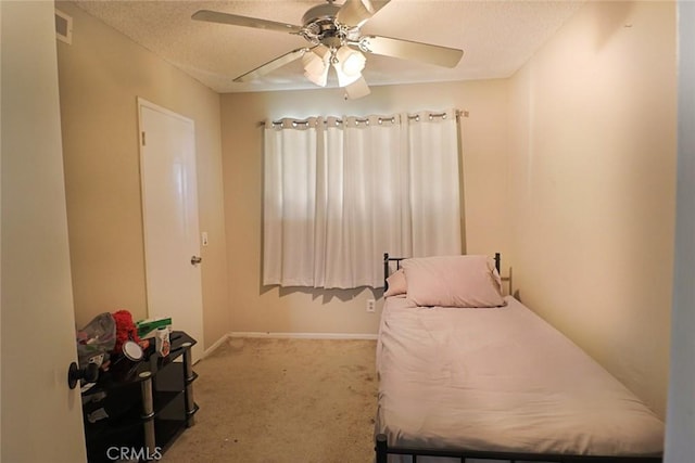 carpeted bedroom with baseboards, visible vents, a textured ceiling, and ceiling fan