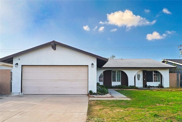 single story home with a front lawn, fence, stucco siding, a garage, and driveway