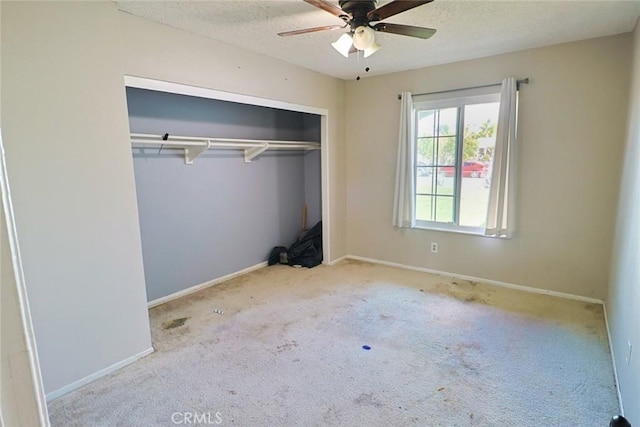 unfurnished bedroom featuring a closet, baseboards, and a textured ceiling