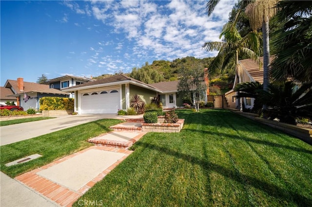 view of front of house with driveway, a front lawn, and an attached garage