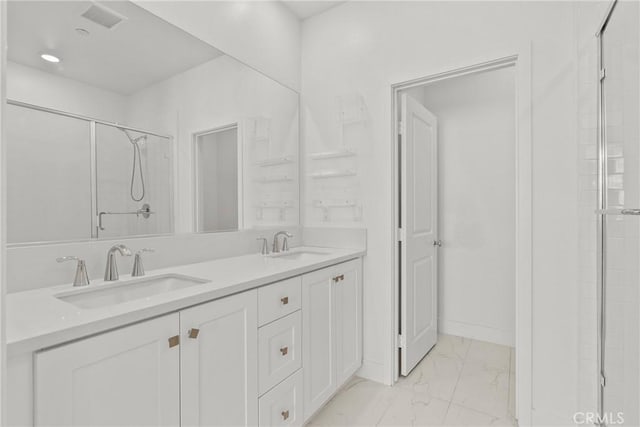 bathroom featuring marble finish floor, an enclosed shower, visible vents, and a sink