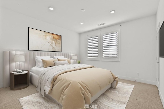 bedroom with light colored carpet, recessed lighting, visible vents, and baseboards