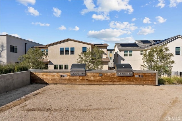 view of yard featuring a residential view, fence, and exterior kitchen