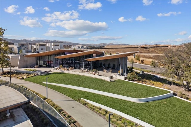 view of community featuring a yard, a patio, and a residential view