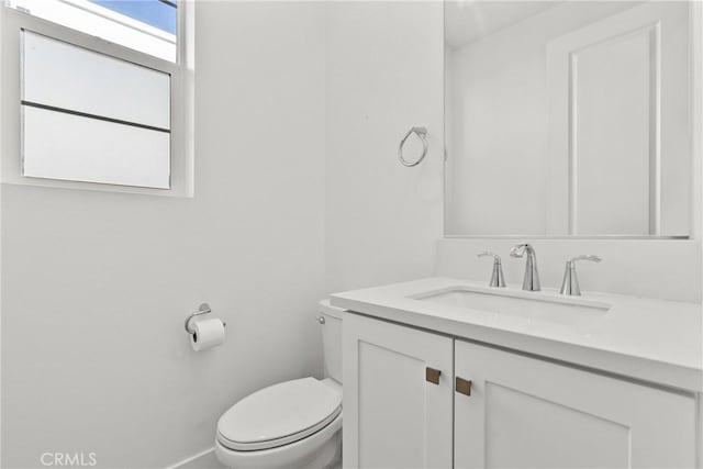 half bathroom with toilet and vanity