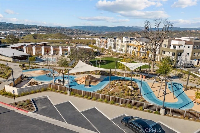 drone / aerial view featuring a residential view and a mountain view