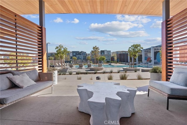 view of patio featuring a residential view, outdoor lounge area, and a community pool