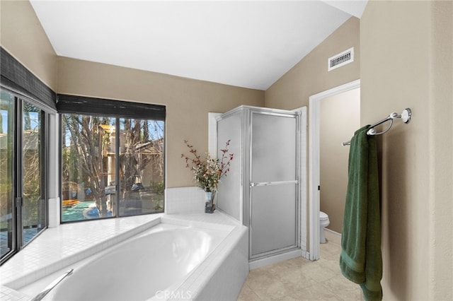 bathroom with a stall shower, plenty of natural light, and visible vents