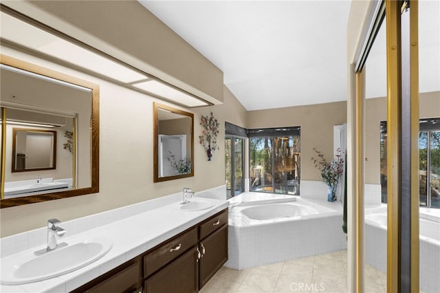 bathroom with vaulted ceiling, double vanity, a sink, and a bath