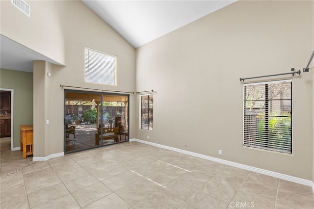 unfurnished room featuring high vaulted ceiling, visible vents, baseboards, and light tile patterned floors