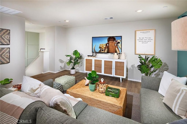 living area featuring baseboards, visible vents, dark wood finished floors, and recessed lighting