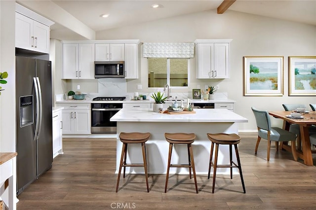 kitchen featuring appliances with stainless steel finishes, a center island, and white cabinetry