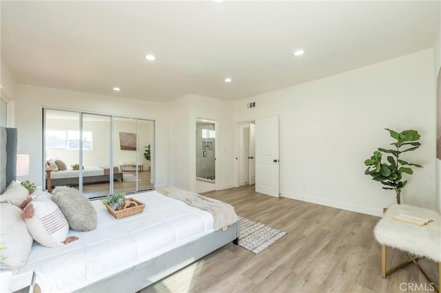 bedroom with light wood finished floors, visible vents, baseboards, a closet, and recessed lighting