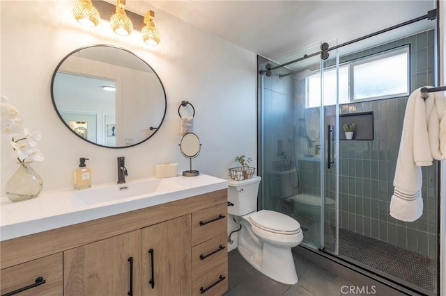 full bath featuring a stall shower, vanity, toilet, and tile patterned floors