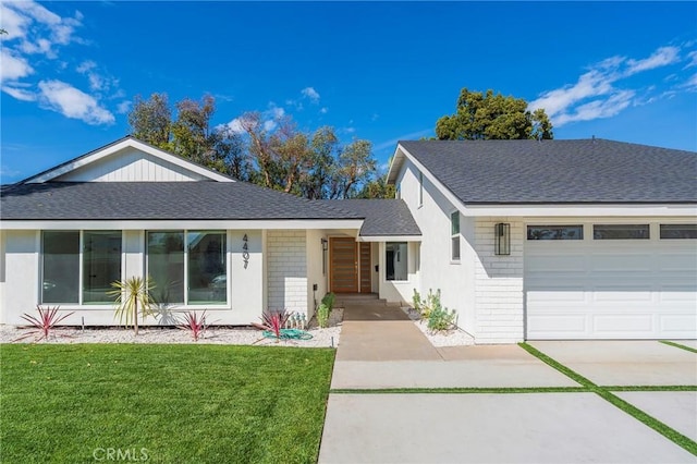 ranch-style house with a garage, a shingled roof, a front yard, and brick siding