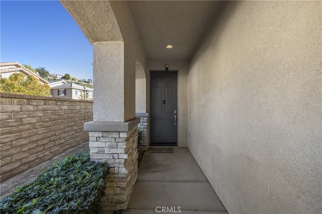 view of exterior entry with stucco siding