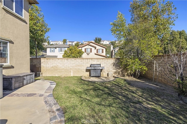 view of yard with a residential view, fence, and a patio