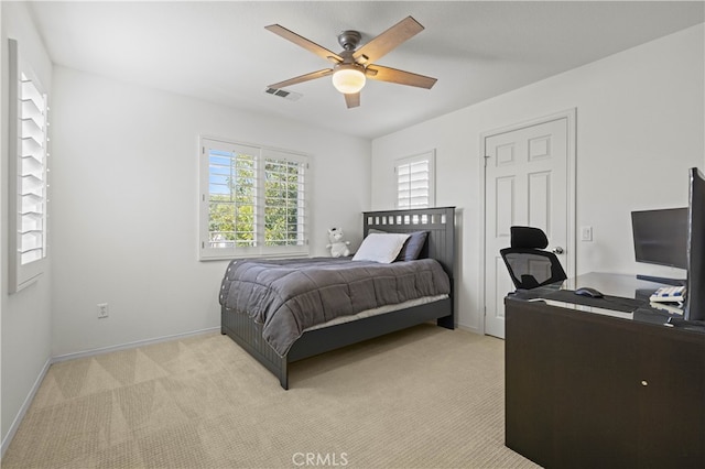 bedroom with baseboards, visible vents, ceiling fan, and light colored carpet