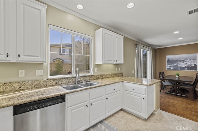 kitchen with ornamental molding, light tile patterned flooring, dishwasher, and a sink