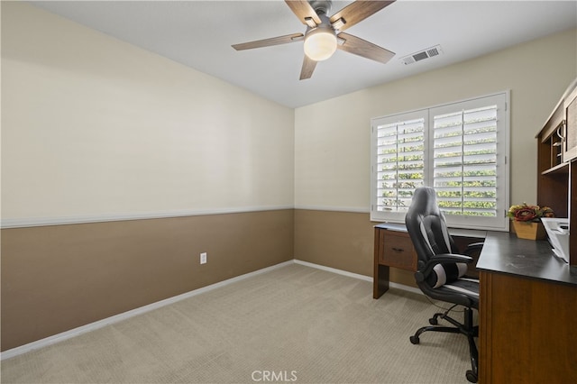 office space featuring visible vents, ceiling fan, light carpet, and baseboards