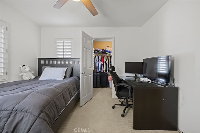 bedroom with a walk in closet, a closet, carpet flooring, and ceiling fan